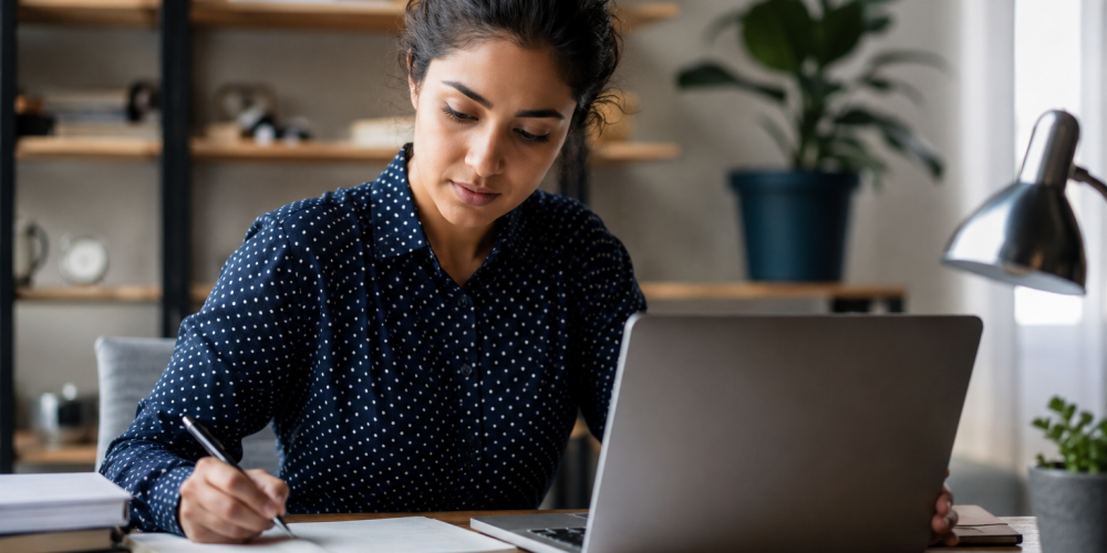 Professional learner balancing work responsibilities and studying through a data analytics course in Coimbatore at Venster School of Excellence using a laptop and analytics reports.